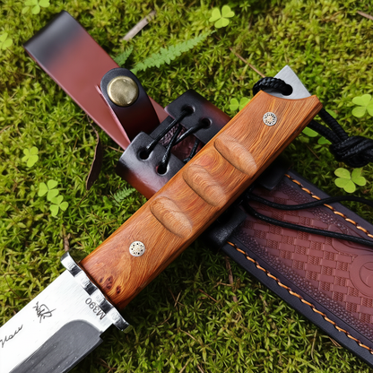 Knife handle close-up moss fern background